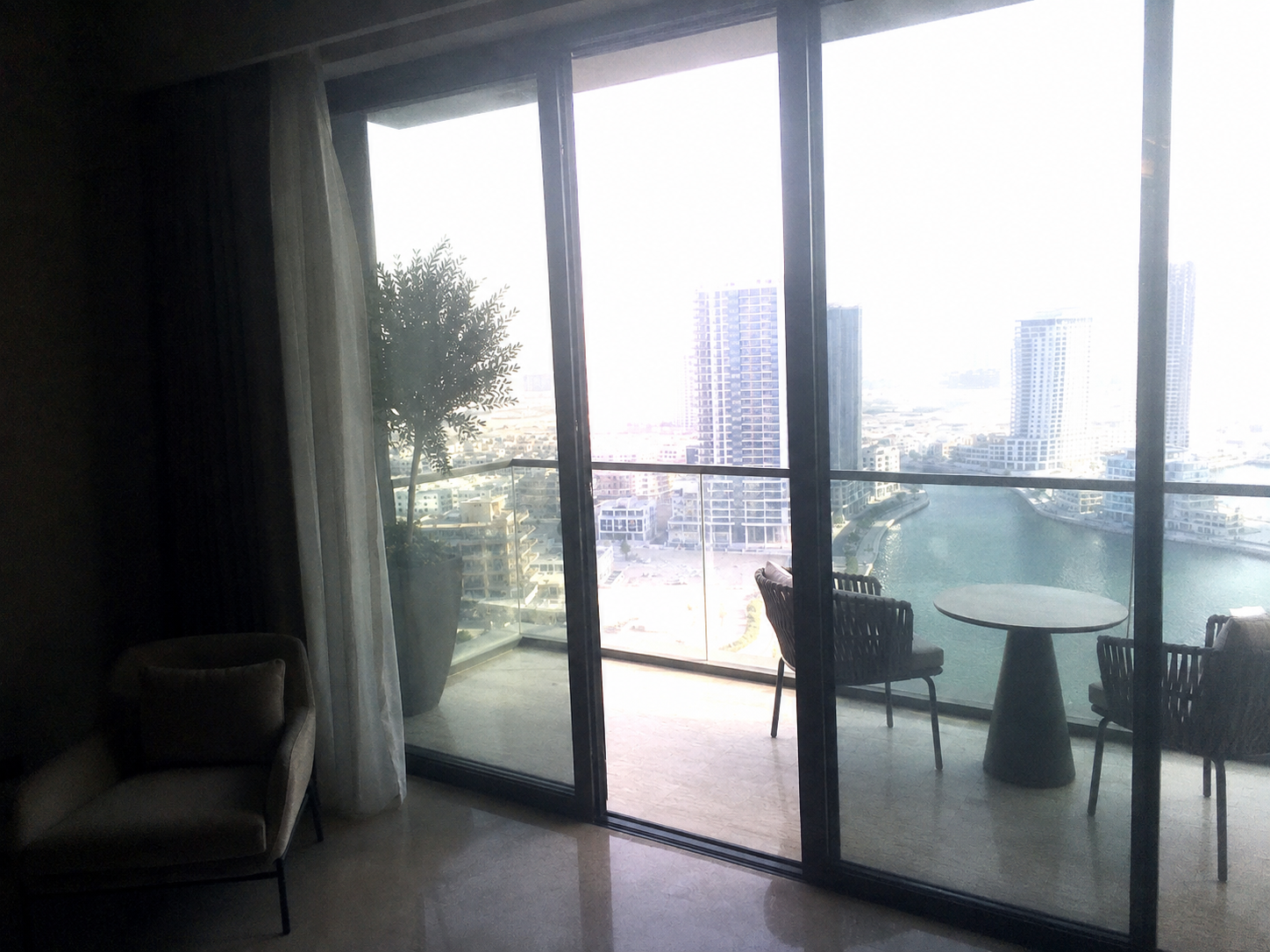 AI-generated balcony and view image with an underexposed interior, glare and blown highlights