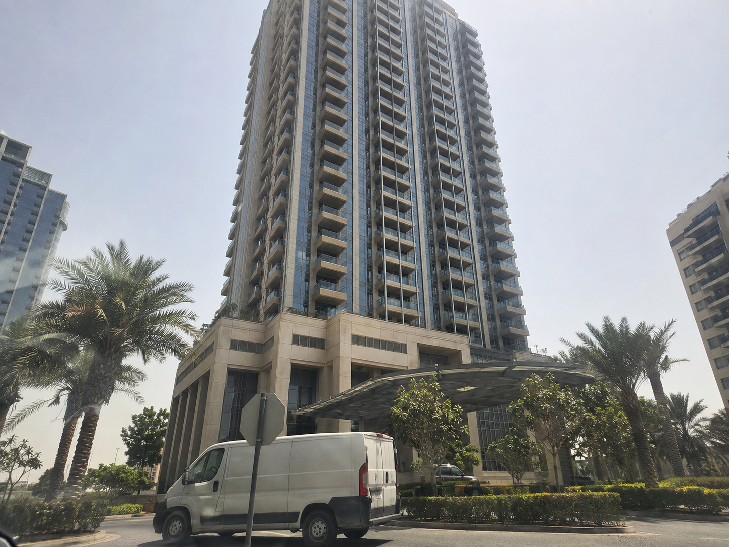 AI-generated residential tower photographed too close with converging lines and obstructions